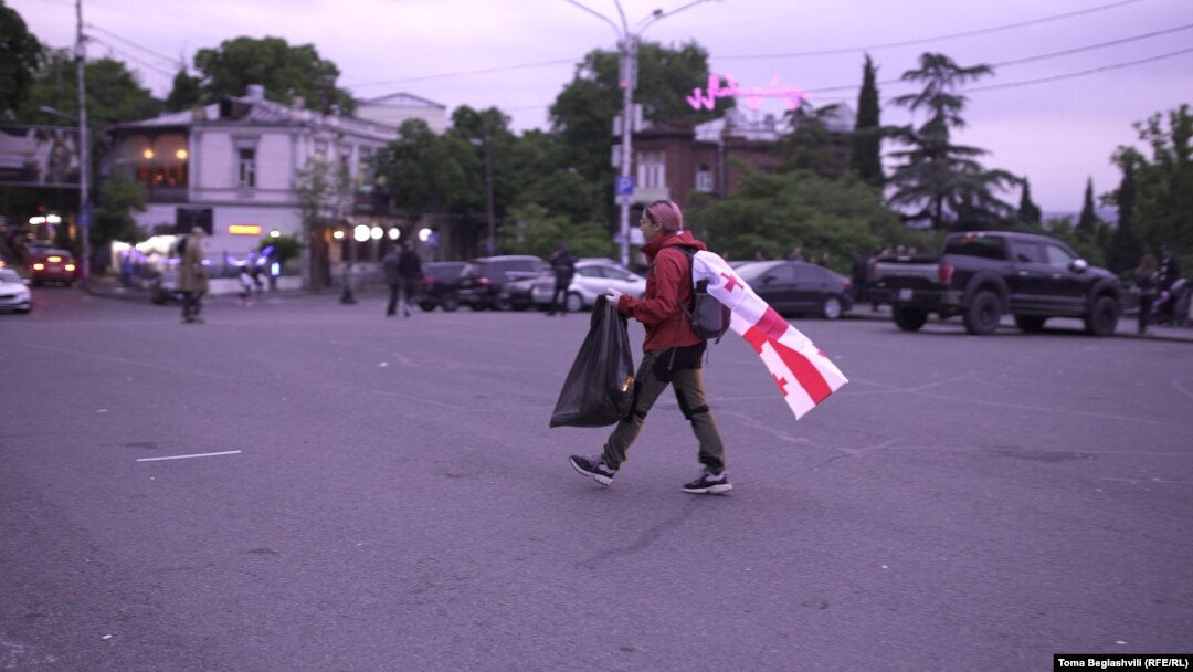 Draped in a Georgian flag, Mariam Pirashvili walks around ensuring that no trash litters the streets.