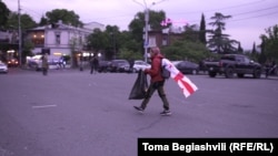 Draped in a Georgian flag, Mariam Pirashvili walks around ensuring that no trash litters the streets.