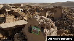 A family picture can be seen on a wall of a damaged house after an earthquake in Afghanistan's Herat Province in October 2023.