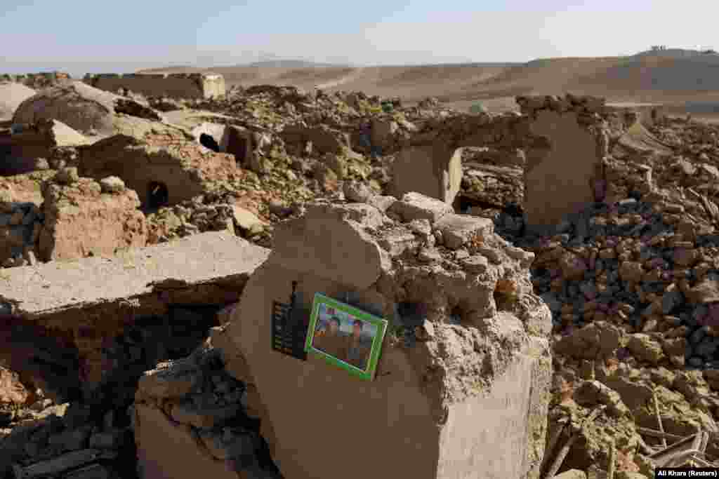 A family photo can be seen among the ruins of a house destroyed in the recent earthquake in Chahak village in the Enjil district of Herat Province, Afghanistan.