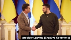 Ukrainian President Volodymyr Zelenskiy (right) greets Swedish Prime Minister Ulf Kristersson in Kyiv on February 15.