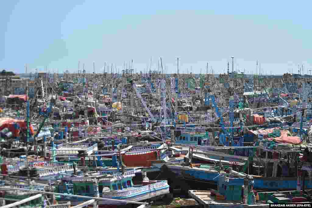 Fishing boats are anchored in port after a warning issued by Pakistani authorities to avoid cyclone Biparjoy in Karachi.