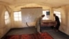 Workers move a desk at an empty educational facility setup by UNICEF after it was closed on April 16 on the orders of the Taliban government.