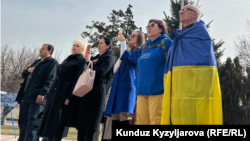 Kyrgyz activists take part in a gathering at the Ukrainian Embassy in Bishkek in a show of support for Ukraine, one year after Russia launched its full-scale military invasion, on February 24.