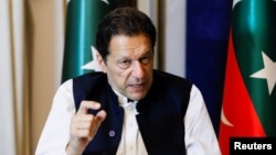 Former Pakistani Prime Minister Imran Khan speaks with reporters in Lahore on March 17.