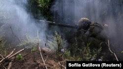 A Ukrainian soldier fires an anti-tank grenade launcher on the front line near the city of Bakhmut in the Donetsk region on July 13.