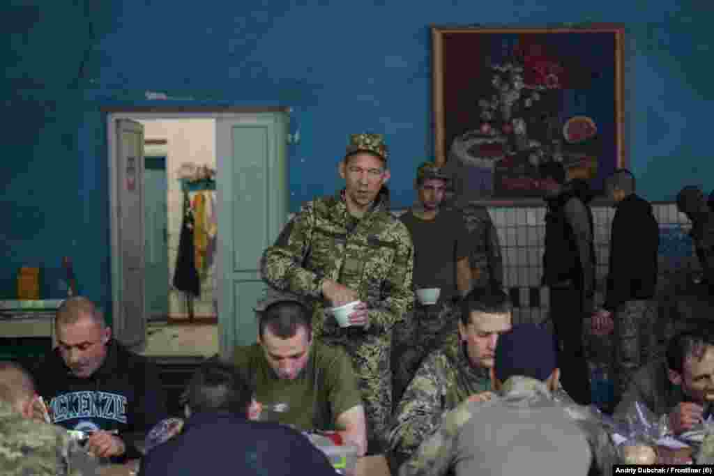 The former inmates, seen here in the canteen, receive equal treatment to regular soldiers, including a paid salary and scheduled time off. They are also permitted unsupervised movement within the training center.