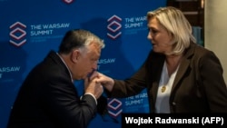 Hungarian Prime Minister Viktor Orban (left) and French National Rally (RN) leader Marine Le Pen attend a 2021 meeting in Warsaw.