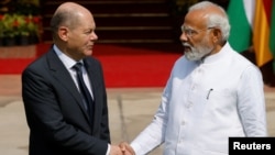 German Chancellor Olaf Scholz (left) shakes hands with Indian Prime Minister Narendra Modi before their meeting in New Delhi on February 25. 