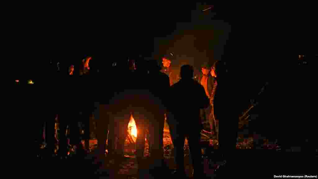 Refugees stay warm by a fire along the road to the Armenian border as they wait for traffic to resume on September 25. Armenia and Azerbaijan have fought two wars in the last three decades over the region, which became a majority ethnic Armenian enclave within the internationally recognized borders of Azerbaijan after the Soviet collapse.