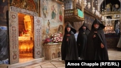 Priests inside the Cathedral of St. James in Jerusalem’s Armenian Quarter during a service on June 14.