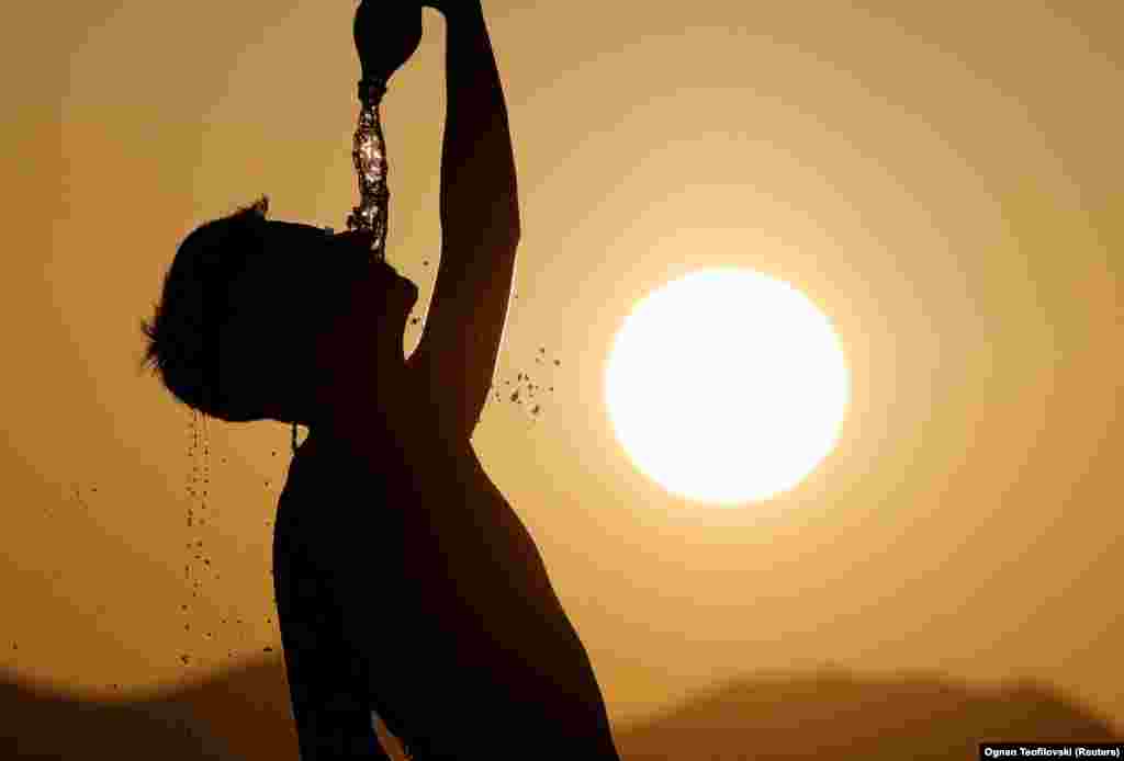 A runner cools down with water in Skopje, North Macedonia.