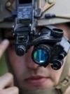 France -- A U.S. Air Force Forward air controller adjusts his night vision goggles 