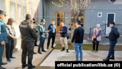Uzbek police conduct a raid in Tashkent on April 12. 