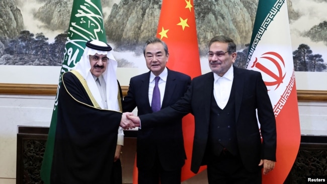 Wang Yi, Ali Shamkhani, and Musaad bin Muhammad al-Aiban pose for cameras in Beijing on March 10 after reaching a deal to resume diplomatic ties between Riyadh and Tehran.