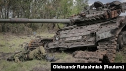 The body of a Russian soldier is seen near a destroyed Russian tank in the newly liberated village of Storozheve in Ukraine's Donetsk region on June 14.