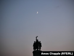 The moon rises over the monument on August 21.