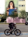 BOSNIA ARTS MURALS -- A man rides a bicycle in front of a mural in Sarajevo, Bosnia and Herzegovina, 03 May 2023. 