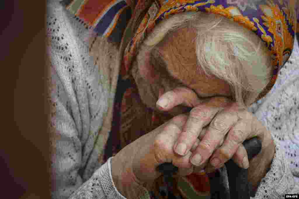 A woman evacuated from the Kursk region bordering Ukraine reacts as she waits to receive humanitarian aid delivered by the Russian Red Cross in downtown Kursk city, Russia.