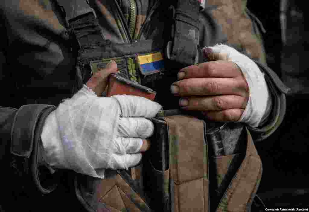 The bandaged hands of a wounded Ukrainian soldier