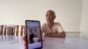 Отец погибшего Мираса Малика показывает фото с ним в телефоне