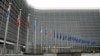 Belgium - People walk past EU headquarters prior to an EU summit in Brussels, Thursday, Oct. 26, 2023.