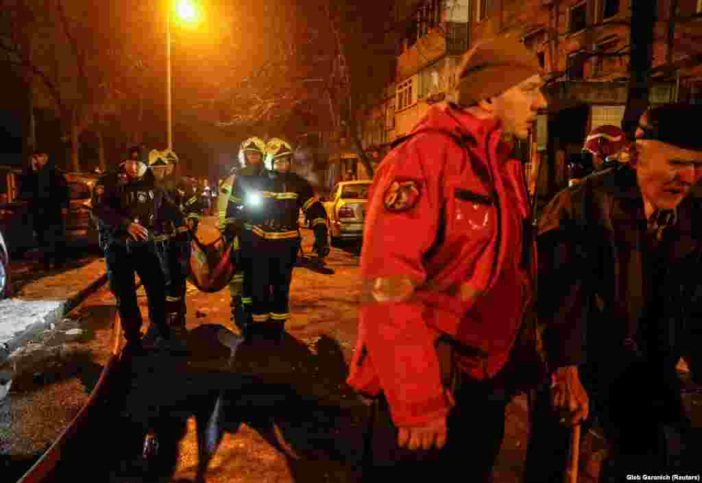 Emergency staff carry a wounded resident to an awaiting ambulance. Debris damaged windows and doors at a children&#39;s hospital in the Dnipro district of Kyiv, though there were no injuries, Mayor Vitali Klitschko wrote on Telegram.