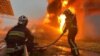 Firefighters extinguish a fire caused by falling missile debris during a Russian attack in the Kyiv region on June 12.