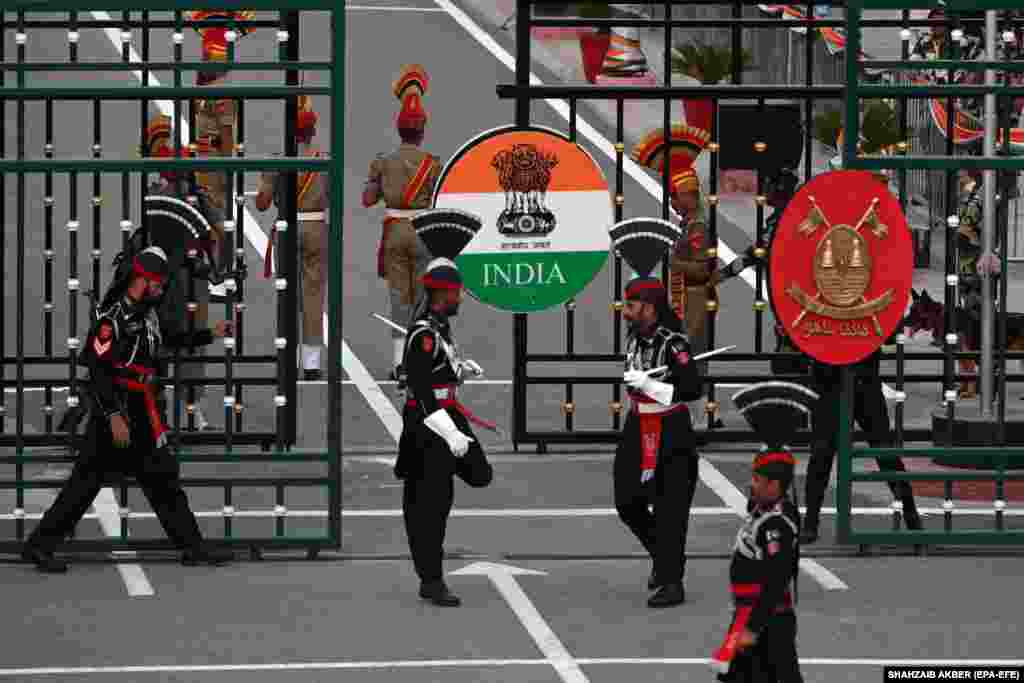 During the ceremony, Indian and Pakistani troops perform theatrical rituals symbolizing the countries&#39; rivalry after independence. The display ends with a brisk, brotherly handshake after the lowering of their national flags and the shutting of the border gates. Following the end of the British Raj in August 1947, both Pakistan and India were proclaimed independent states. The mass migration and ethnic bloodshed that followed the partition left behind a bitter legacy.