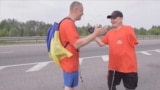 Two Ukrainian amputees, Serhii Khrapko and Oleksandr Shevtsov, walk to raise hospital funds, May, Kiyev, Ukraine