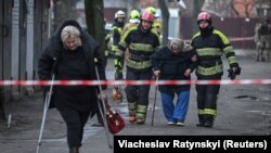 Рятувальники евакуюють жительку будинку, пошкодженого російським ударом, Київ, 21 березня 2024 року
