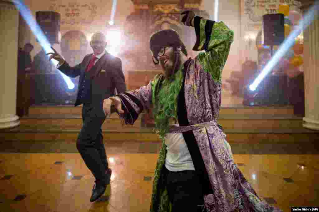 Men of the Ukrainian Jewish community dance during Purim celebrations and a festive meal at the Great Choral Synagogue in Kyiv.
