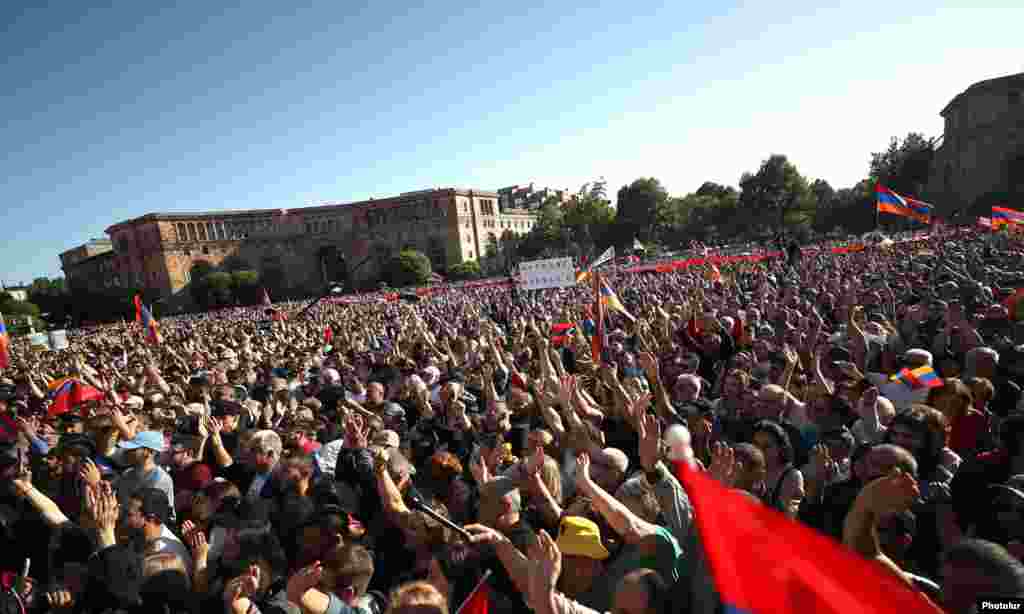 Tens of thousands of Armenians rallied in the center of Yerevan on May 9 amid calls by an outspoken Armenian archbishop for Prime Minister Nikol Pashinian and his government to resign over a land deal with rival Azerbaijan.