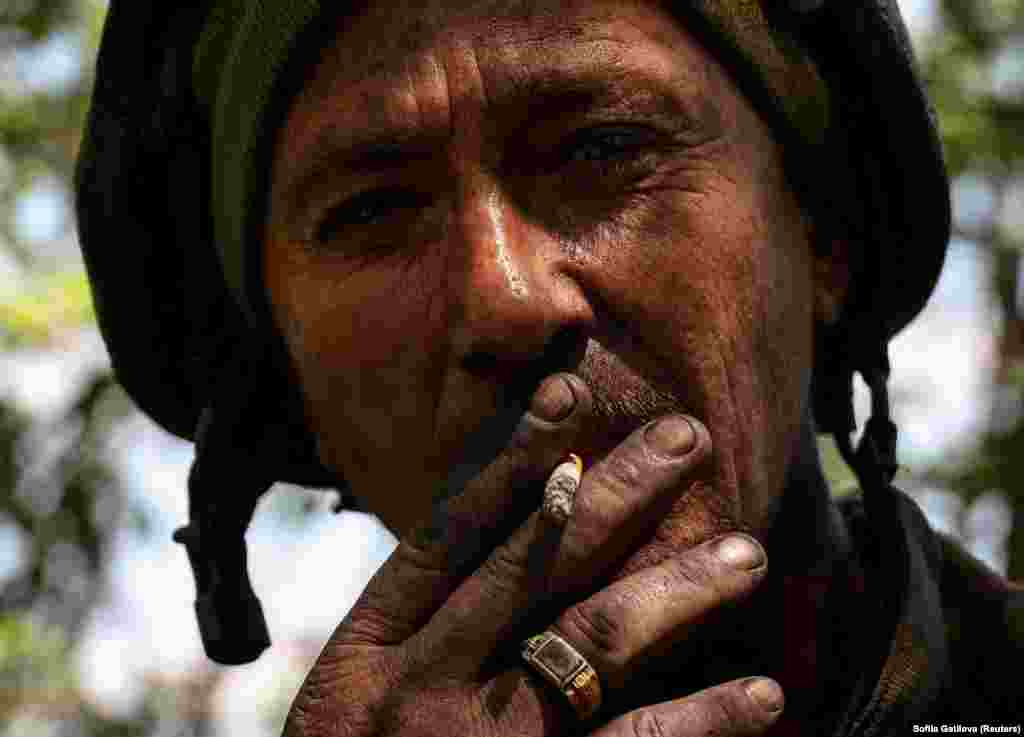 A Ukrainian soldier of the 57th Separate Motorized Infantry Brigade smokes at his position near the town of Chasiv Yar in the Donetsk region of Ukraine.