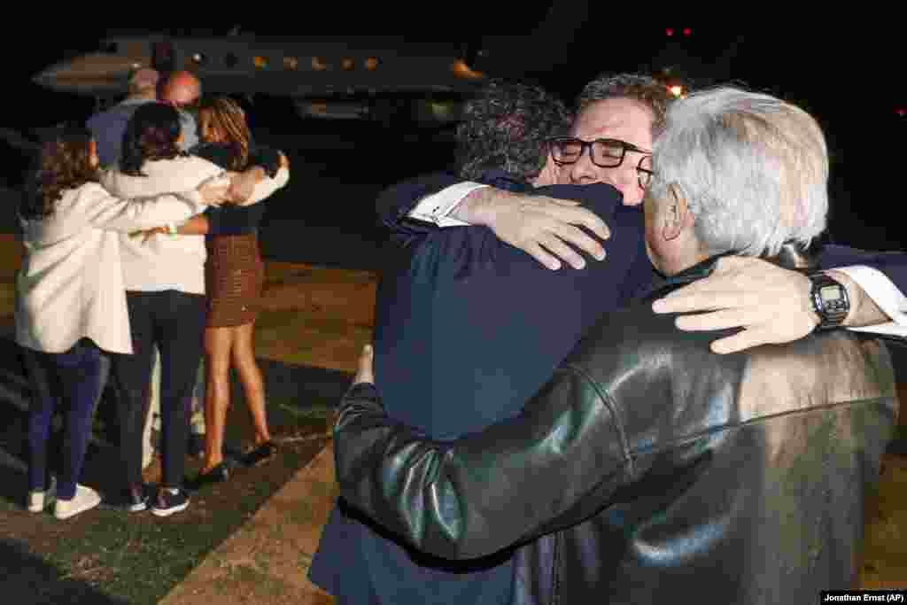 Family members embrace freed Americans as they arrive from Iran at Davison Army Airfield at Fort Belvoir, Virginia, on September 19. They were released in a prisoner swap deal between the United States and Iran.