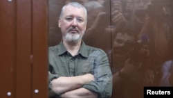 Russian nationalist Kremlin critic and former military commander Igor Girkin, also known as Igor Strelkov, who is charged with inciting extremist activity, sits in a defendents' box at a court hearing in Moscow on July 21.