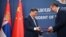 Chinese leader Xi Jinping (left) and Serbian President Aleksandar Vucic exchange agreements during a signing ceremony on May 8 in Belgrade.