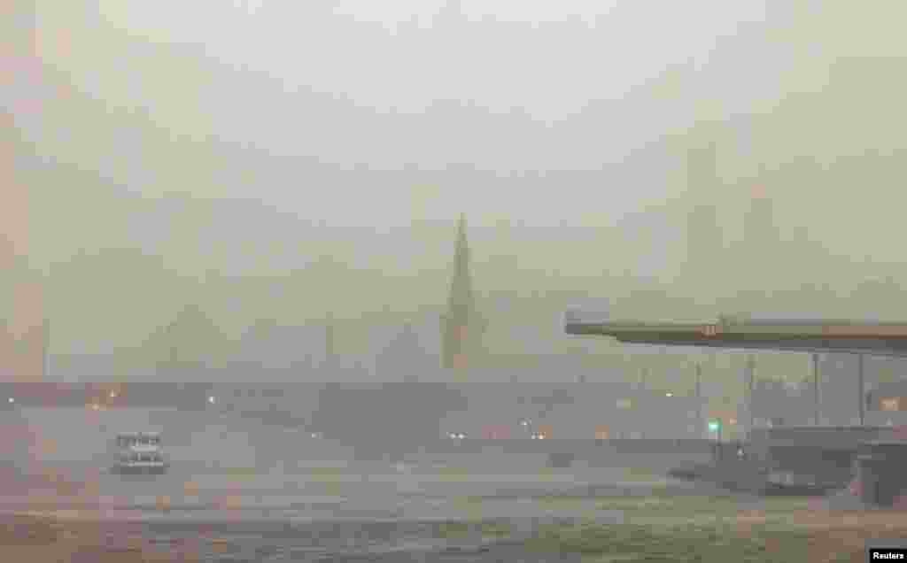  The Kremlin is barely visible as a storm approaches Moscow on June 20. The storm killed two people and injured nine. &nbsp; 