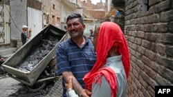 Pastor Javed Bhatti weeps beside his burned house in a Christian neighborhood in Jaranwala on August 17, a day after an attack by Muslim men following allegations that Christians had desecrated the Koran.