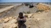 A boy waits to be evacuated to government relief camps before the expected arrival of a cyclone in the Sujawal district of Sindh Province on June 12.