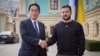 Japanese Prime Minister Fumio Kishida (left) and Ukrainian President Volodymyr Zelenskiy greet each other during a meeting in Kyiv on March 21.