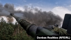 An AHS Krab artillery piece fires a 155 mm shell in Ukraine's Kharkiv region.