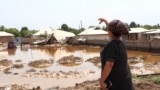 A woman gestures toward flooded homes in the village of Surkhob, in northern Tajikistan, on May 27.&nbsp;<br />
<br />
<br />
&nbsp;