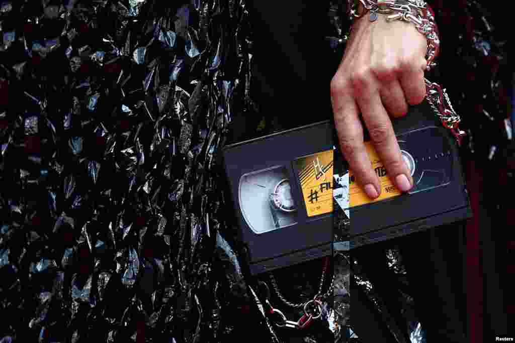 Videokaseta kao torbica na crvenom tepihu 76. filmskog festivala u Kanu, 23. maj.