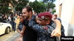 Armenia - Police arrest an antigovernment protester in Yerevan, May 13, 2024.