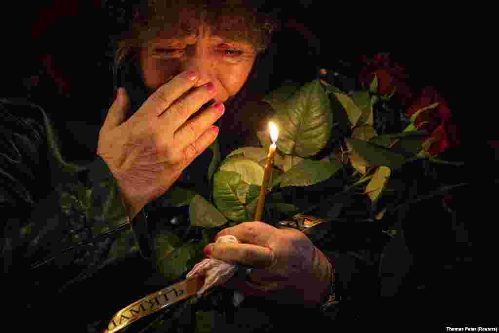 A Ukrainian woman in Kyiv mourns during the funeral of her grandson who was killed fighting Russian troops at the front.&nbsp;