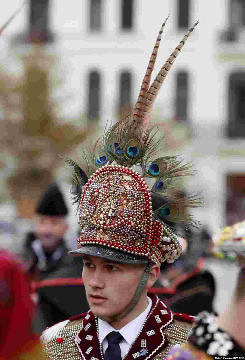 A festival participant wears a hat topped with peacock feathers. The event brought together some examples of the many distinct winter traditions that have been observed throughout Romania for centuries.&nbsp;