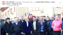 Într-o fotografie din octombrie 2014 postată de TSD Voluntari, Ştefan Godei stă chiar în spatele Gabrielei Firea. El şi Costin Simion (sacou negru, lângă actualul ministru) au fost singurele persoane menţionate cu link în postare.