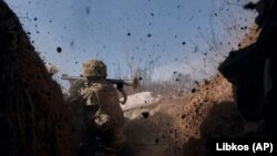 Ukraine -- A Ukrainian soldier of the 28th brigade fires a grenade launcher on the frontline during a battle with Russian troops near Bakhmut, Donetsk region, Ukraine, Friday, March 24, 2023.