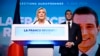 Марин Ле Пен, символ французских ультраправых, выступает в ходе кампании перед выборами в Европарламент. Справа от нее (и на плакате на заднем плане) - преемник Ле Пен на посту лидера партии "Национальное объединение" Жордан Барделла